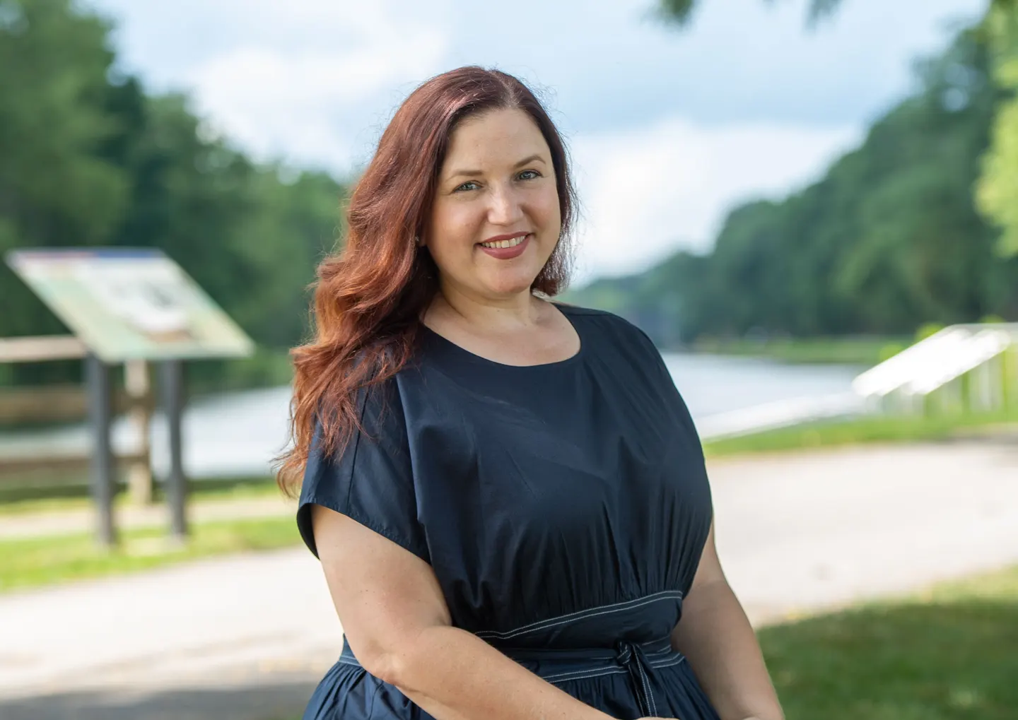 Jen Lunsford smiling, seated beside the canal