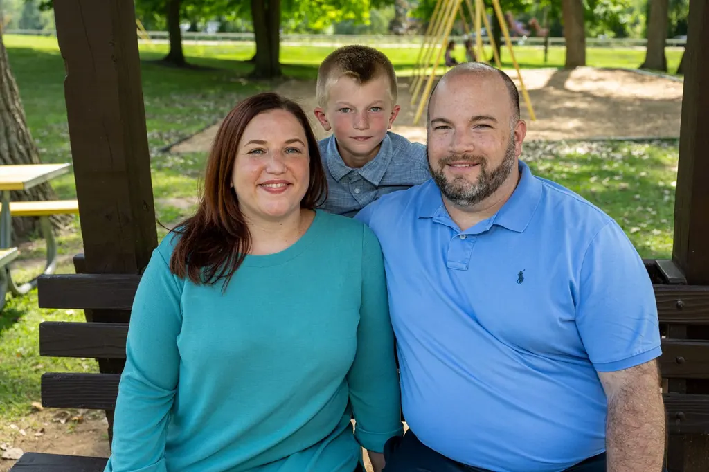 Jen Lunsford with her husband and son on a park bench
