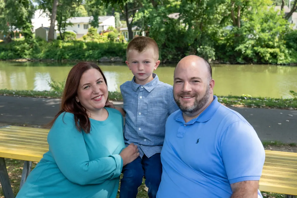 Jen Lunsford with her husband and son on a bench along the canal