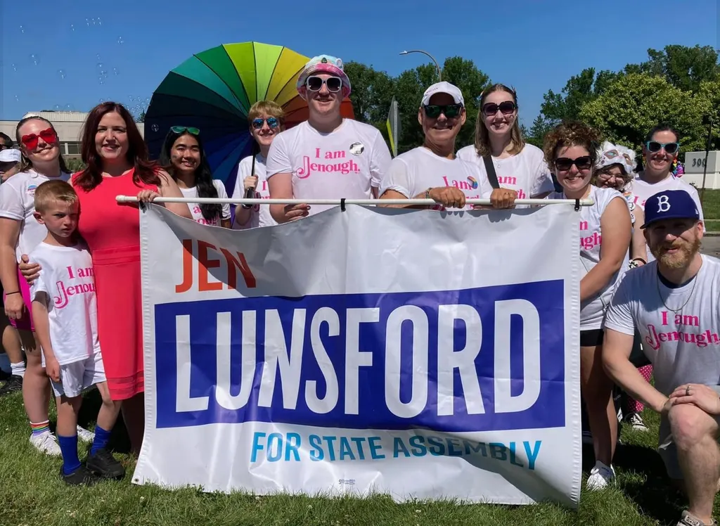 Volunteers holding a Lunsford for State Assembly banner at an outdoor event